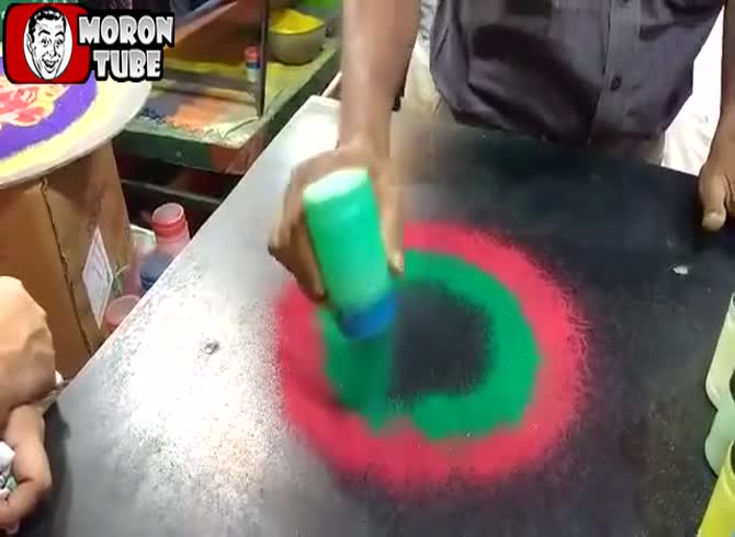 Video :Visitors watch as an ephemeral rangoli is created